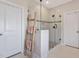 Modern glass enclosed shower with white marble-look tile and decorative ladder at 3215 Jones Lake Rd, Fuquay Varina, NC 27526