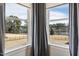 Picturesque view of the lake from large windows, filling the room with natural light and providing serene scenery at 3215 Jones Lake Rd, Fuquay Varina, NC 27526