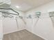 Well-lit walk-in closet with adjustable shelving, ample storage and neutral carpeting for an organized space at 3401 Rosebush Dr, Zebulon, NC 27597