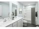 Stylish bathroom with double vanities, modern fixtures, and a shower-tub combination with a neutral-toned curtain at 351 Tormore Dr, Sanford, NC 27330