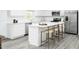 Bright and airy kitchen with white cabinets, a quartz countertop island and seating for four, stainless steel appliances at 351 Tormore Dr, Sanford, NC 27330