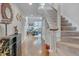 Inviting foyer features hardwood floors, staircase, and a glimpse into the bright living area at 360 Linden Close, Pittsboro, NC 27312