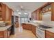 Traditional kitchen with natural wood cabinets, skylights, and modern appliances at 360 Linden Close, Pittsboro, NC 27312
