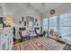 Cozy sunroom featuring a large window, hardwood floors and comfortable seating at 360 Linden Close, Pittsboro, NC 27312