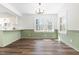 Dining room featuring modern light fixture, natural light from two large windows, and wood-look flooring at 411 E 2Nd St, Kenly, NC 27542