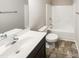 Bathroom with a modern vanity, toilet, and a shower-tub combo, complete with neutral wall colors and vinyl flooring at 480 Stonewall Dr, Mebane, NC 27302