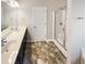 Bright bathroom featuring a double sink vanity, glass-enclosed shower, and modern finishes at 480 Stonewall Dr, Mebane, NC 27302