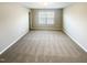 Large bedroom featuring neutral carpeting and walls, and natural light from a window at 480 Stonewall Dr, Mebane, NC 27302