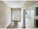 Welcoming entryway with wood-look flooring and a white front door, leading into an open-concept living space at 480 Stonewall Dr, Mebane, NC 27302