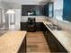 Modern kitchen featuring dark cabinets, granite countertops, and stainless steel appliances at 480 Stonewall Dr, Mebane, NC 27302