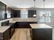 Modern kitchen with dark cabinets, granite countertops, stainless steel appliances and kitchen island at 480 Stonewall Dr, Mebane, NC 27302