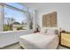 Bedroom showcasing a large window and woven headboard in a brightly lit space at 521 N Mangum St # 12, Durham, NC 27701