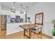 Dining area view featuring a modern wood table, stylish pendant lighting and kitchen in the background at 521 N Mangum St # 12, Durham, NC 27701