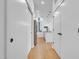 Hallway view leading to a modern kitchen with stainless steel appliances and an island at 521 N Mangum St # 12, Durham, NC 27701