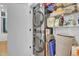 Convenient laundry area featuring stacked washer and dryer with storage shelves at 521 N Mangum St # 12, Durham, NC 27701