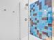 Close-up of a modern shower with blue and brown tiling at 521 N Mangum St # 12, Durham, NC 27701