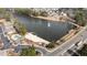 Stunning aerial view of a lake community featuring a sandy beach, docks, and well-maintained surroundings at 5213 Orabelle Ct, Raleigh, NC 27606