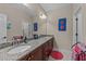 Large bathroom with granite countertops, dual sinks, and a large framed mirror at 5213 Orabelle Ct, Raleigh, NC 27606