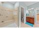 Bright bathroom featuring a glass enclosed shower with a built-in bench and neutral tiling at 5213 Orabelle Ct, Raleigh, NC 27606