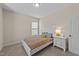 Inviting bedroom with a white bed frame, colorful bedding, and a bright lamp on a nightstand at 5213 Orabelle Ct, Raleigh, NC 27606