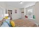 Bright bedroom featuring colorful bedding, artwork, and a window seat offering natural light at 5213 Orabelle Ct, Raleigh, NC 27606