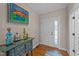 Bright foyer featuring hardwood floors, console table, and beautiful artwork at 5213 Orabelle Ct, Raleigh, NC 27606
