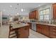Open-concept kitchen with stainless steel appliances, an island with seating, and backyard views at 5213 Orabelle Ct, Raleigh, NC 27606