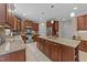 Well-equipped kitchen featuring stainless steel appliances, a center island, and tiled backsplash at 5213 Orabelle Ct, Raleigh, NC 27606
