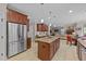 Open kitchen featuring a large island, stainless steel appliances, and seamless flow into the living area at 5213 Orabelle Ct, Raleigh, NC 27606