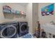 Functional laundry room equipped with a washer, dryer, and sink for convenient chores at 5213 Orabelle Ct, Raleigh, NC 27606