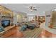 Open-concept living room featuring a stone fireplace and hardwood floors at 5213 Orabelle Ct, Raleigh, NC 27606