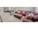 Spacious living area featuring a large sofa, coffee table, and neutral-toned carpeting at 5213 Orabelle Ct, Raleigh, NC 27606