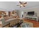 Cozy living room featuring a ceiling fan, stylish furniture and décor, and hardwood floors at 5213 Orabelle Ct, Raleigh, NC 27606