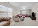 Comfortable living room with plush carpet, large windows, and a cozy seating area at 5213 Orabelle Ct, Raleigh, NC 27606