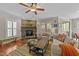 Cozy living room featuring a stone fireplace, hardwood floors, and comfortable seating at 5213 Orabelle Ct, Raleigh, NC 27606
