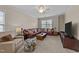 Inviting living room with ample seating, natural light, and comfortable furnishings at 5213 Orabelle Ct, Raleigh, NC 27606