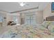 Inviting main bedroom showcasing a cozy bed, ceiling fan, and a view to a sitting area at 5213 Orabelle Ct, Raleigh, NC 27606