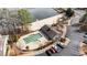 Aerial view showcases a community pool, sandy beach, and pond at 5213 Orabelle Ct, Raleigh, NC 27606