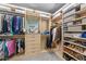 A spacious walk-in closet with custom shelving and ample storage for shoes, folded and hanging clothes at 5213 Orabelle Ct, Raleigh, NC 27606
