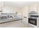 Charming kitchen featuring white appliances, bright cabinetry, and a granite countertop bar at 529 Hillsborough # H-6, Chapel Hill, NC 27514