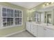 Bathroom featuring double sink vanity, large window, tile floor, and neutral paint at 6013 Kohler Ln, Raleigh, NC 27616