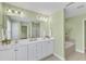 Bathroom featuring double sinks, white cabinets, tub, and neutral tones at 6013 Kohler Ln, Raleigh, NC 27616