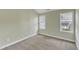 Neutral bedroom with carpet, two windows and baseboard trim at 6013 Kohler Ln, Raleigh, NC 27616