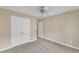 Neutral bedroom featuring wall-to-wall carpet and a large closet at 6013 Kohler Ln, Raleigh, NC 27616