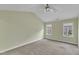 Spacious bedroom featuring vaulted ceilings, neutral carpet, and natural light from two windows at 6013 Kohler Ln, Raleigh, NC 27616