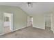 Bedroom view with ensuite bathroom entrance, walk-in closet, and hallway access at 6013 Kohler Ln, Raleigh, NC 27616