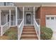 Charming entryway with brick steps, white railings, and a stylish front door with a transom window at 6013 Kohler Ln, Raleigh, NC 27616