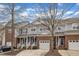Charming brick townhome with garage and covered porch with mature trees and manicured landscaping at 6013 Kohler Ln, Raleigh, NC 27616