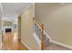 Inviting foyer with hardwood floors, staircase, and view of the living area with fireplace at 6013 Kohler Ln, Raleigh, NC 27616