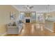 Bright living room featuring a fireplace, ceiling fan, hardwood floors and abundant natural light at 6013 Kohler Ln, Raleigh, NC 27616